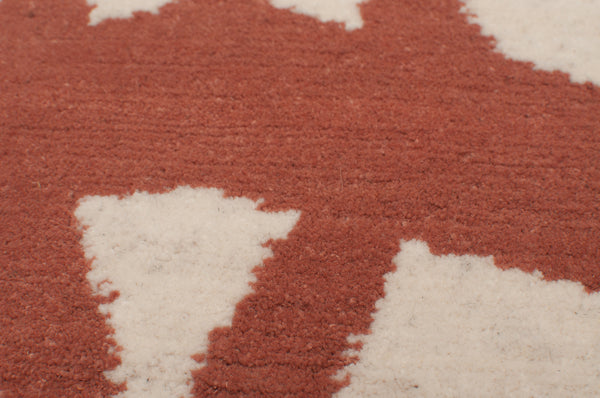 Close up of Chaise, a rug with a geometric design by Amala Carpets - handmade with hand-carded Himalayan sheep wool. Featured in Interior Design Magazine's Fall Market Tabloid 2015