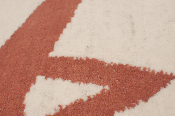 Close up of Chaise, a rug with a geometric design by Amala Carpets - handmade with hand-carded Himalayan sheep wool. Featured in Interior Design Magazine's Fall Market Tabloid 2015